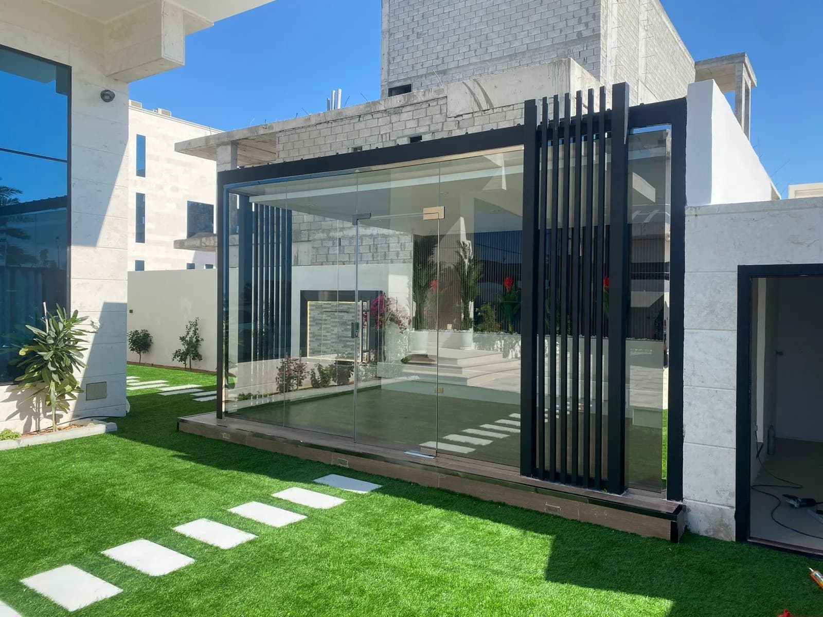 Glass Room, Artificial Grass & Wall Waterfall in Al Bateen